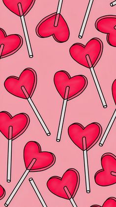 a pink background with red hearts and lollipops on sticks in the shape of heart