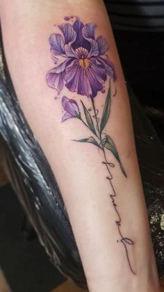 a purple flower with the word faith written in cursive writing on its arm