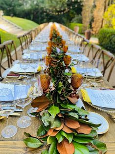 a long table is set with plates and place settings