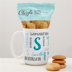 a coffee cup filled with cookies next to a stack of cookies