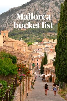 people walking down a street with mountains in the background and text overlay that reads mallorca bucket list