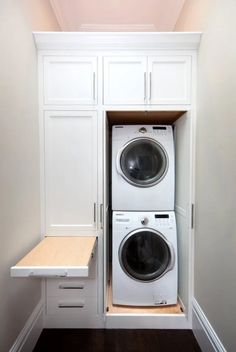 a white washer and dryer in a small room