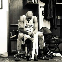 a basketball player sitting in the locker room