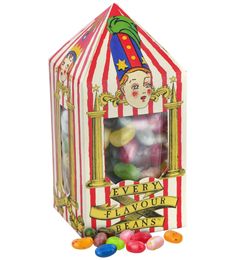 a box filled with jelly beans next to a clown's face on top of it