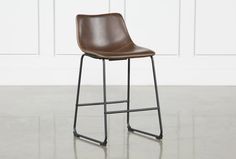 a brown leather stool sitting on top of a metal frame stand in front of a white wall