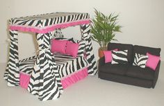 a living room with zebra print furniture and a potted plant