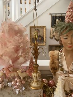 there is a mannequin wearing a pink hat next to other ornaments and decorations