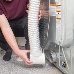 a man is working on an air conditioner