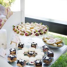 several desserts and pastries are displayed on a table