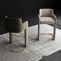 two chairs sitting on top of a rug next to each other