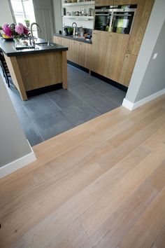 a kitchen with wooden floors and an island