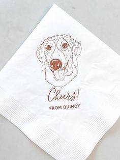 a white napkin with a brown dog's face on it and the words cheese from quincy