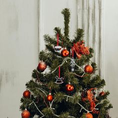 a small christmas tree with ornaments on it