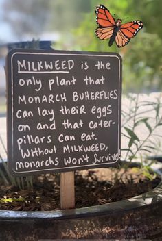 a sign that is on top of a potted plant in front of a window