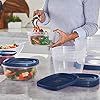 a woman standing in front of a table filled with food and plastic containers on it