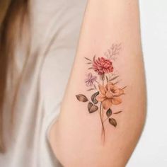 a woman with a flower tattoo on her arm