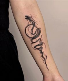 a woman's arm with a snake tattoo on it