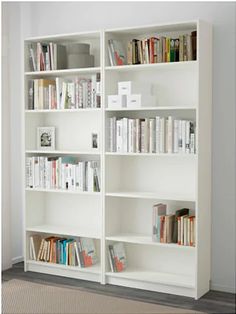 a white bookshelf filled with lots of books