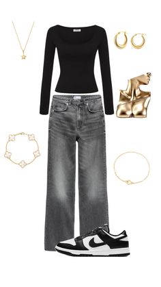 a woman in black shirt and jeans with gold accessories