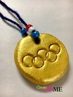 a gold medal with the olympic symbol on it