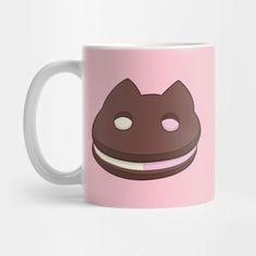 a pink coffee mug with a cat face on it