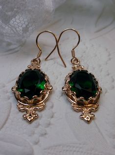 "Simulated Emerald Earrings Pin Design#E18 Custom Made These are Victorian reproduction estate earrings in rose gold plated sterling silver set with flawless A-quality simulated green emerald gemstones. Each stunning 6ct oval cut gem is 14mm long (9/16th\") and 10mm in width (3/8th\"). The earrings are 1 3/4th inches long. Notice the beautiful fleur de lis on the bottom and top of the setting. These lovely earrings were fashioned from an antique Victorian floral brooch. A gift box is included an Classic Rose Gold Emerald Jewelry, Nickel-free Rose Gold Earrings For Formal Events, Nickel-free Rose Gold Earrings For Formal Occasions, Rose Gold Nickel-free Earrings For Formal Events, Victorian Rose Gold Jewelry For Pierced Ears, Elegant Nickel-free Emerald Earrings, Victorian Rose Gold Earrings For Gift, Rose Gold Victorian Earrings For Gift, Victorian Style Rose Gold Earrings For Gift