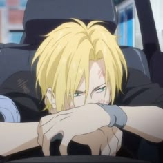 a blonde haired man sitting in the back seat of a car with his hand on his chest