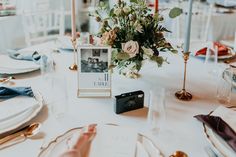 the table is set with flowers and candles