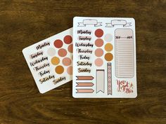 two planner stickers sitting on top of a wooden table next to eachother