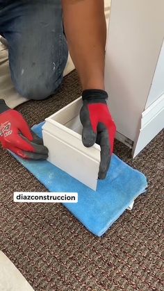 a person in red gloves is working on the floor