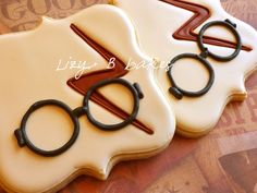 three decorated cookies with harry potter symbols on them