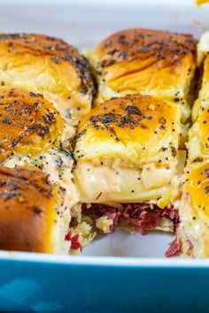 a casserole dish filled with ham and cheese sliders covered in melted cheese