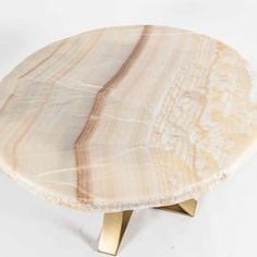 a marble table with gold legs on a white background