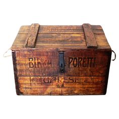 an old wooden box with writing on the front and bottom, sitting against a white background