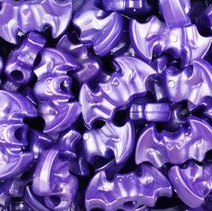 many purple plastic objects are stacked together