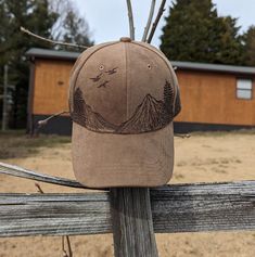 a brown hat sitting on top of a wooden fence