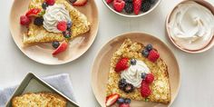 three plates with slices of french toast topped with berries and whipped cream