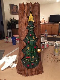 a wooden christmas tree with decorations on it