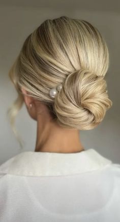 a woman with blonde hair in a low bun