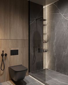 a bathroom with a toilet, shower and sink in it's center wall next to a walk - in shower