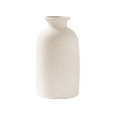 a white vase sitting on top of a table