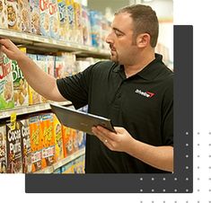 a man in a grocery store checking out cereal