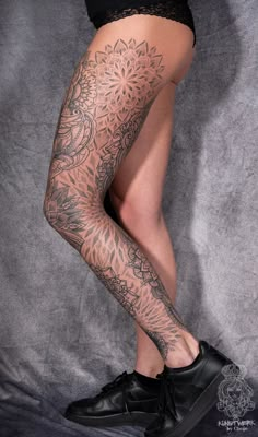 a woman's legs with tattoos on them