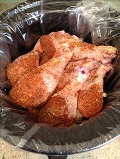 some meat is in a plastic bag on the counter and it looks like they are ready to be cooked