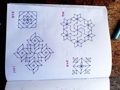 the paper has four different designs drawn on it, and one is blue with black ink