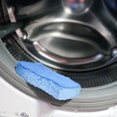 a blue sponge sitting on top of a dryer