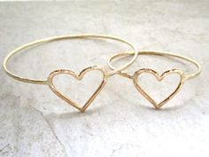 Gold Heart Baby Bangle~ Beautiful 14 k gold fill heart baby bangle handmade with love in Hana, Maui, Hawaii. Perfect gift idea for baby shower or baby luau. Lightly hammered and polished for that extra sparkle! You can add on a pearl or puka shells from the drop down menu. For correct sizing measure the circumference of the babies hand around the largest part of the hand under the thumb and pinky joint with the thumb tucked in towards pinky finger, fingers out straight. Bangle has to be able to Cute Gold Stackable Jewelry, Handmade Cute Heart Bracelet, Gold Heart Bracelet Nickel Free, Gold Nickel-free Heart Bracelet For Gift, Nickel-free Gold Heart Bracelet For Gift, Nickel-free Gold Heart Bracelet As Gift, Gold Bracelets With Heart Beads, Cute Gold Jewelry For Anniversary, Gold Heart-shaped Stackable Bracelets