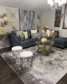 a living room filled with lots of furniture and decor on top of a wooden floor