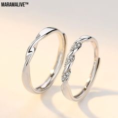 two white gold wedding rings with diamonds on each side and the words marmalive written in