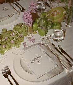 a table set with plates, silverware and napkins